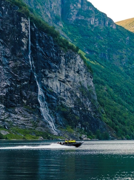 RIB boat on Geirangerfjord near Hellesylt waterfall, Norway.