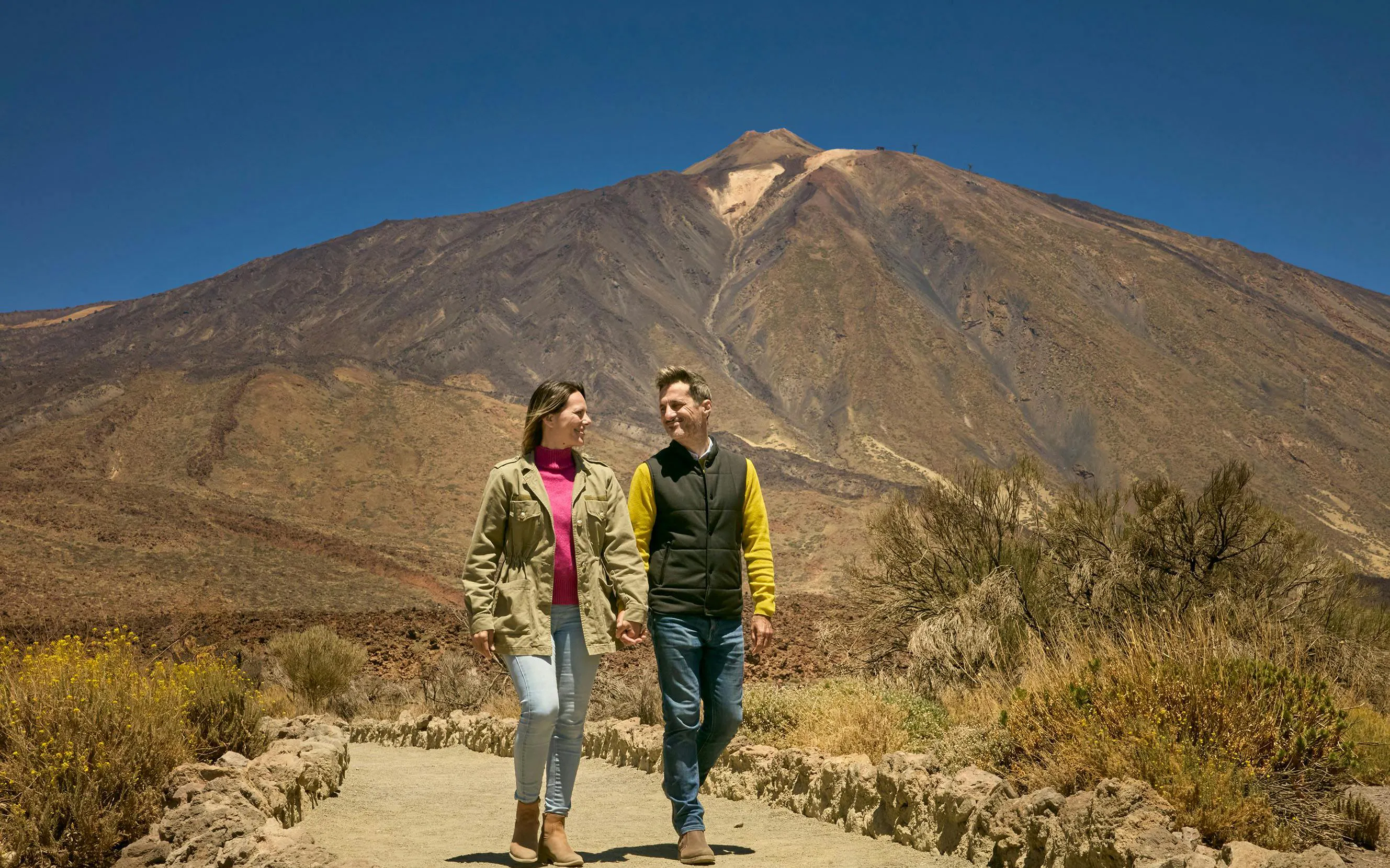 Guests walking on Mount Teide trail during guided tour in Tenerife.