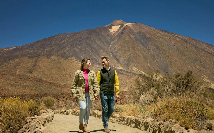 Guests walking on Mount Teide trail during guided tour in Tenerife.