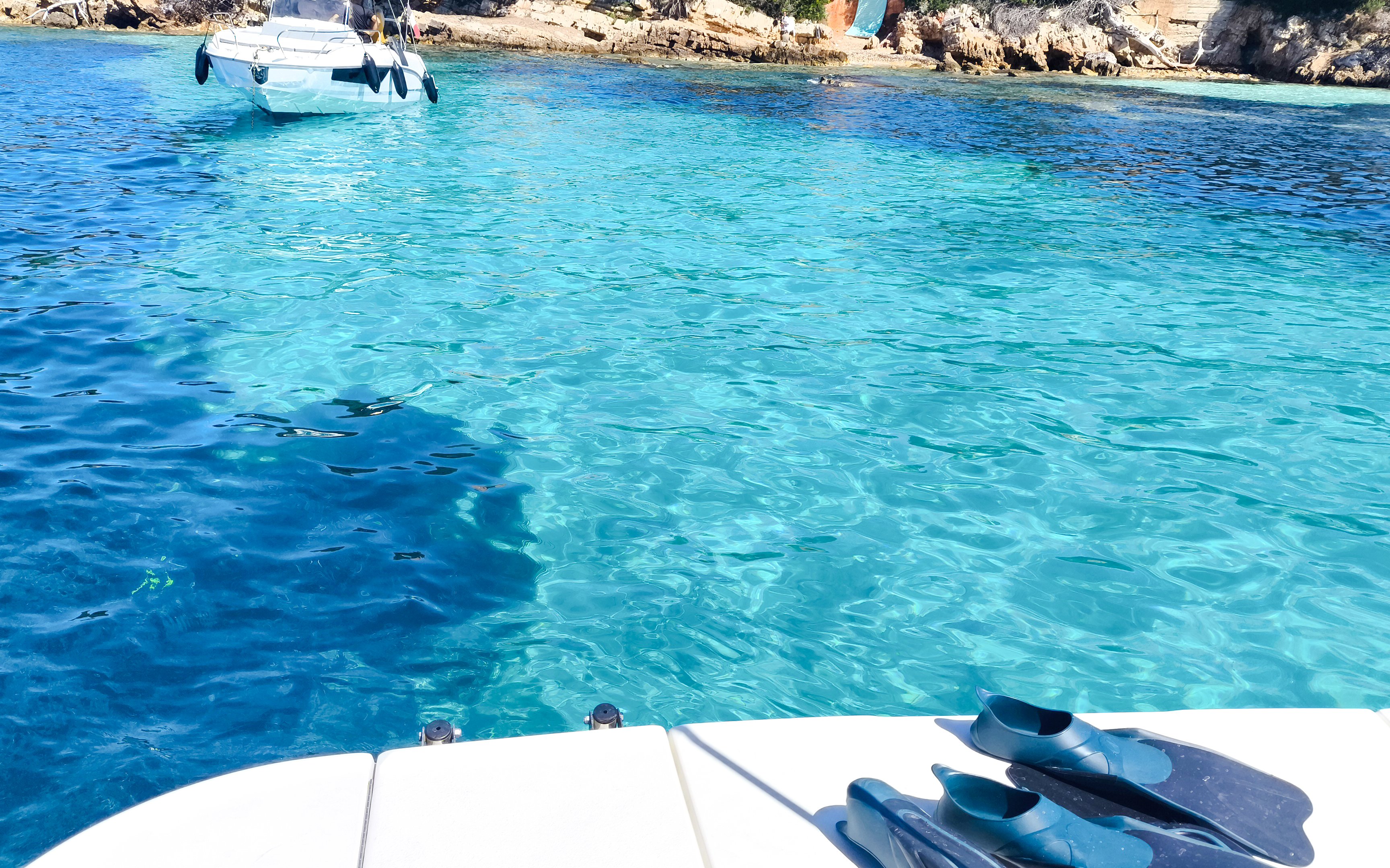 Private boat anchored near Lérins Islands with snorkeling gear on deck, Cannes.