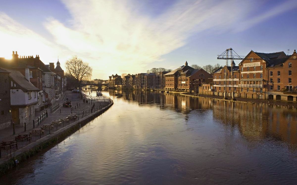 York riverside view with historic buildings along the Ouse, ideal for sightseeing cruise.
