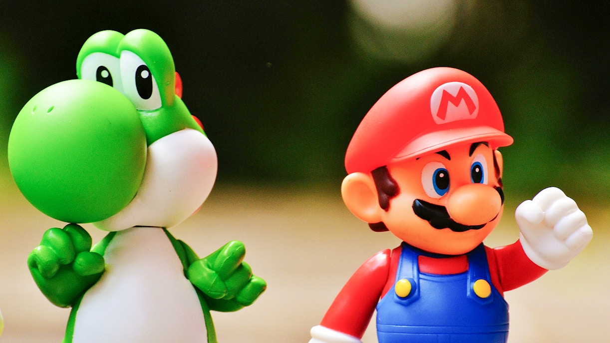Super Mario and Yoshi figurines standing together.
