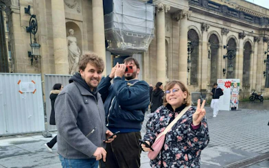 Participants enjoying Bordeaux Murder Mystery game in front of historic building.