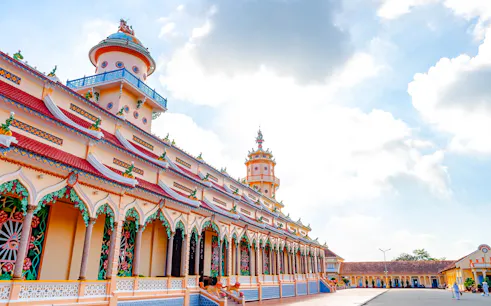 Cao Dai Temple exterior with ornate architecture, Ho Chi Minh City tour.