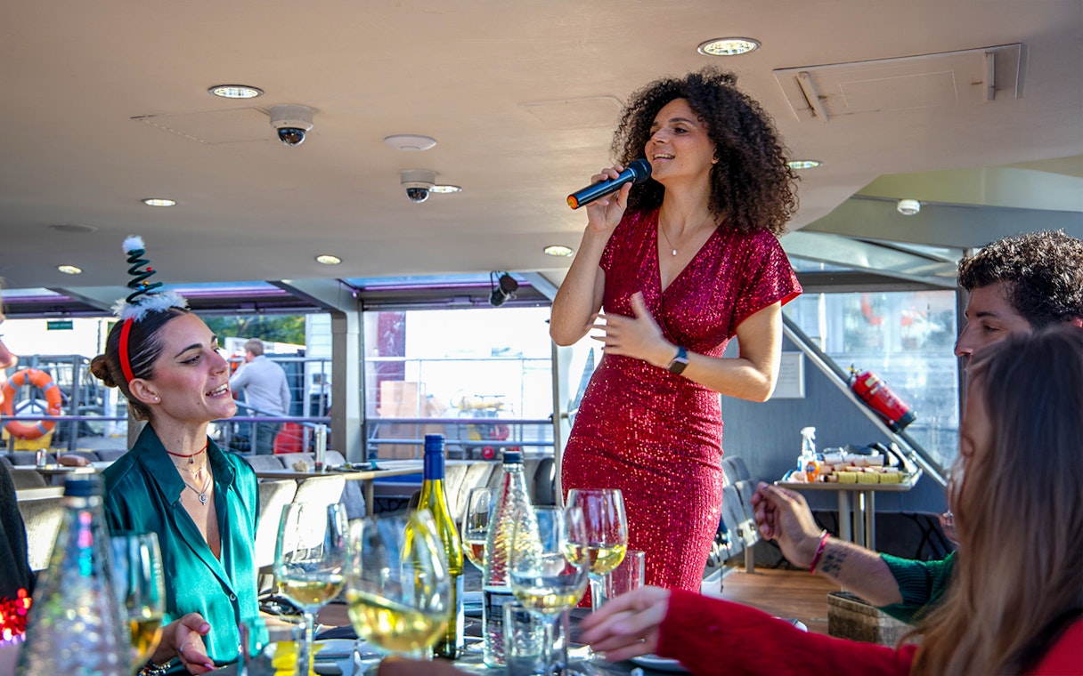 Vocalist performing for guests on a Christmas cruise.