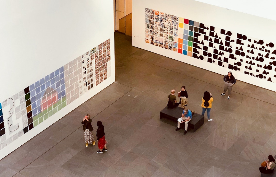 Visitors viewing artwork at Museum of Modern Art NYC.