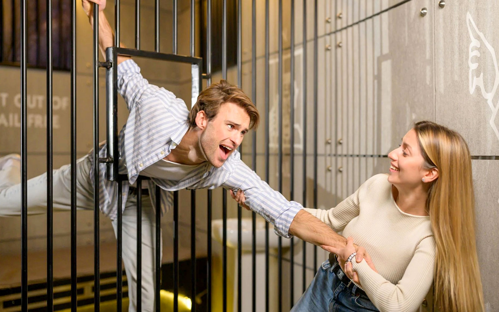 Woman trying to help friend escape monopoly jail at Monopoly Dreams Melbourne
