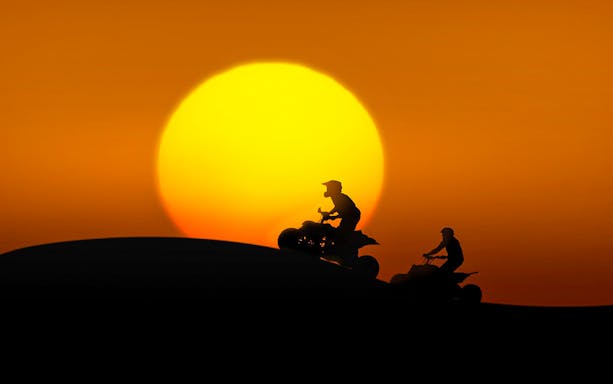 Quad bikers riding at sunset during a 3-hour guided tour in Bosa.