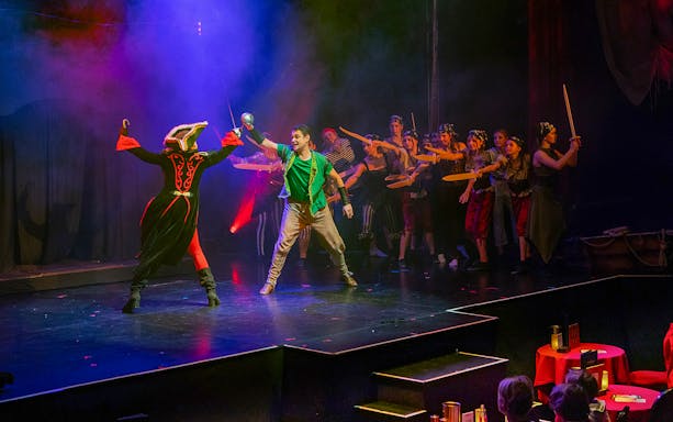 Stage performance of Zimt & Zauber: THE WIZARD OF OZ with actors in vibrant costumes.