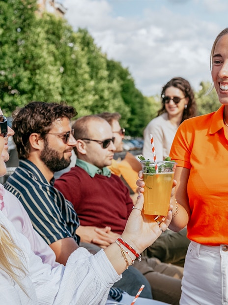 Guests enjoying drinks on an Amsterdam evening cruise with onboard bar.
