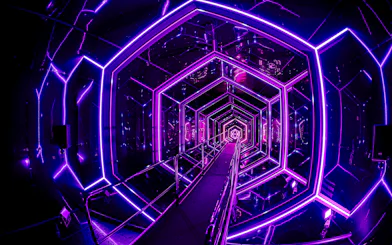 Neon-lit tunnel inside Amaze Amsterdam with geometric patterns.