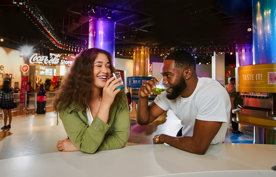 Visitors sampling drinks at the Taste it! Exhibit, World of Coca-Cola, Atlanta.