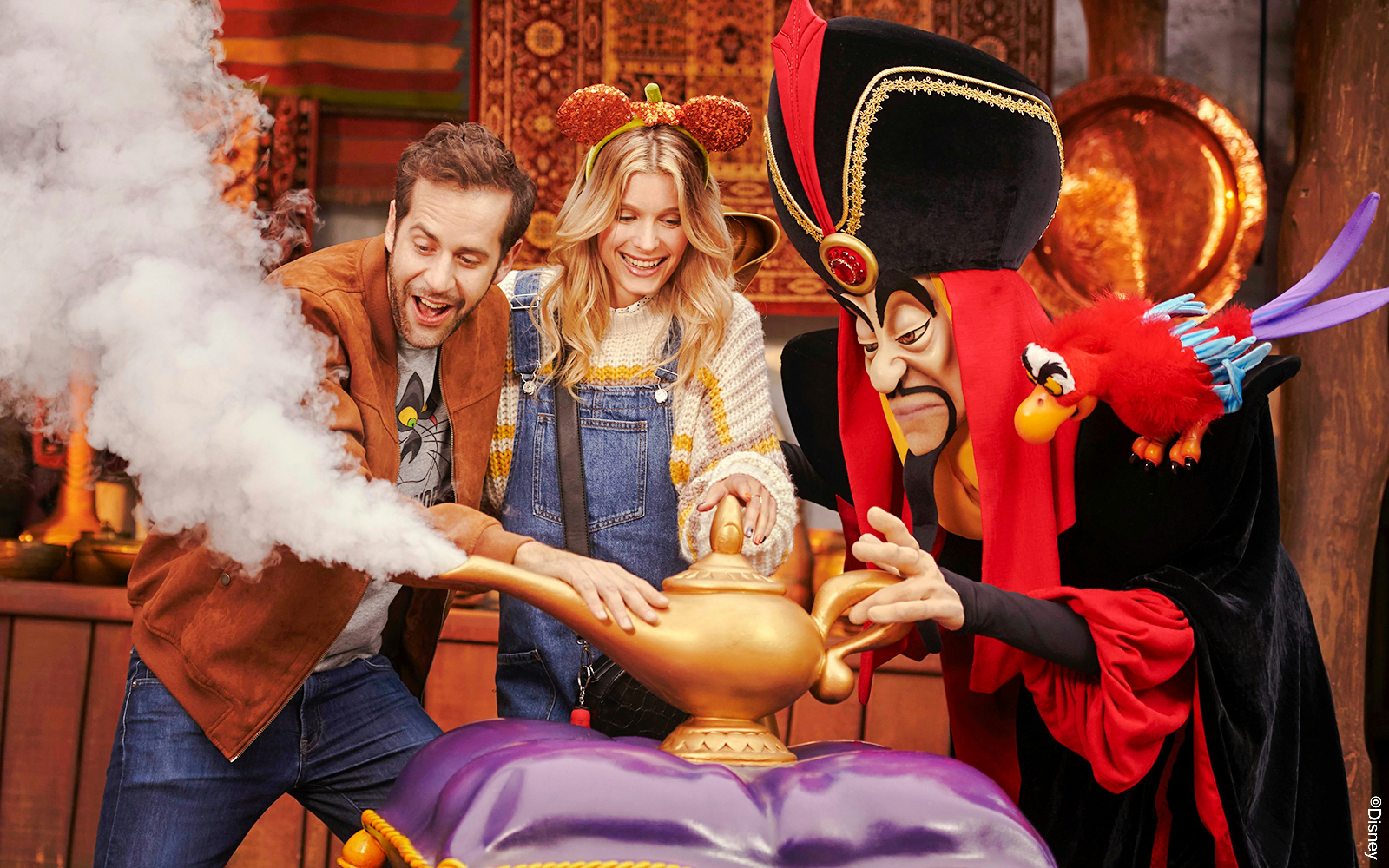 Guests interacting with Jafar at Disneyland Paris with Halloween decorations.