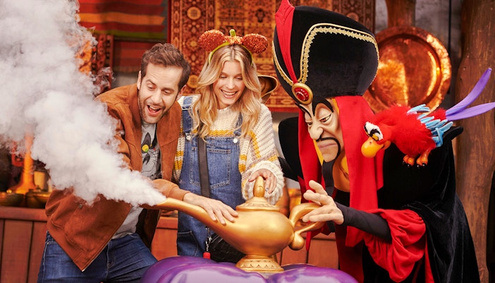 Guests interacting with Jafar at Disneyland Paris with Halloween decorations.