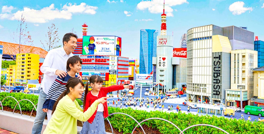 Family exploring miniature Tokyo skyline at Legoland Japan.