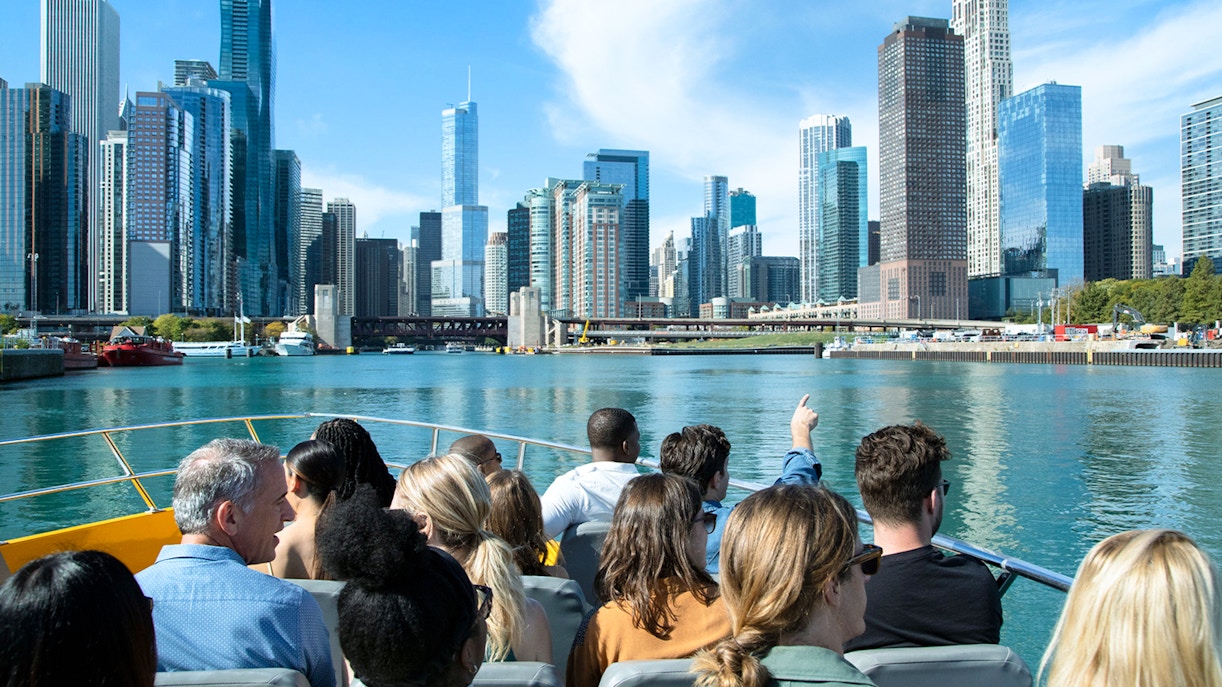 Tourists on a boat viewing Chicago skyline during Sea Dog Architecture Cruise.