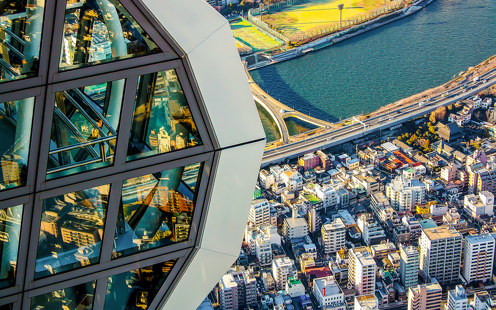 View from Tokyo Skytree overlooking cityscape and river.