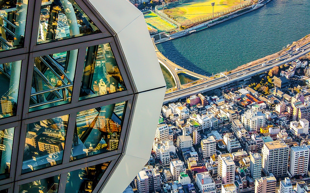 View from Tokyo Skytree overlooking cityscape and river.