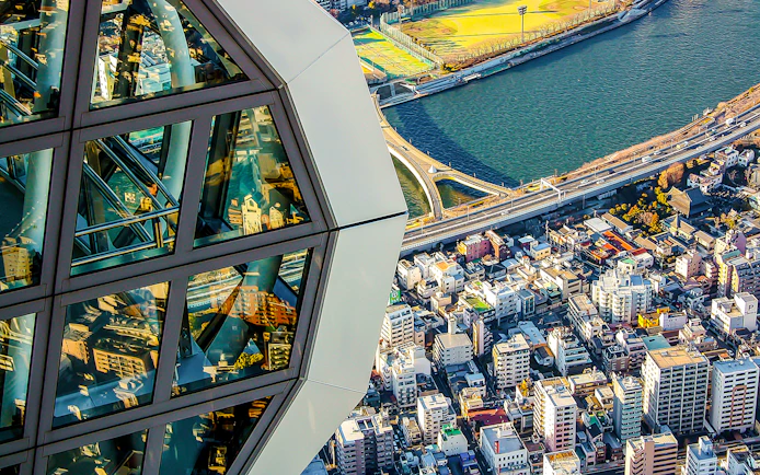 View from Tokyo Skytree overlooking cityscape and river.