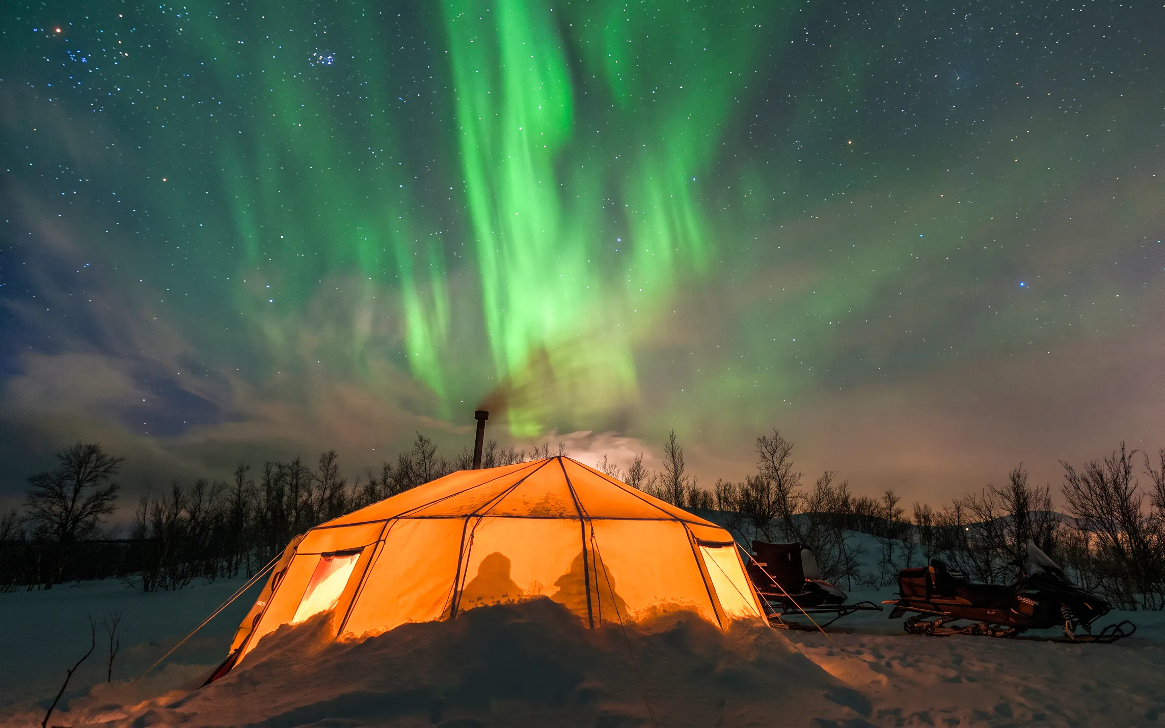Tent under northern lights in Abisko during photography tour.