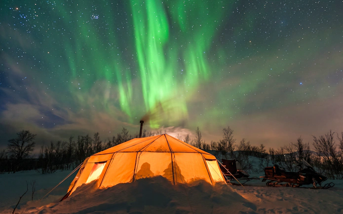 Tent under northern lights in Abisko during photography tour.