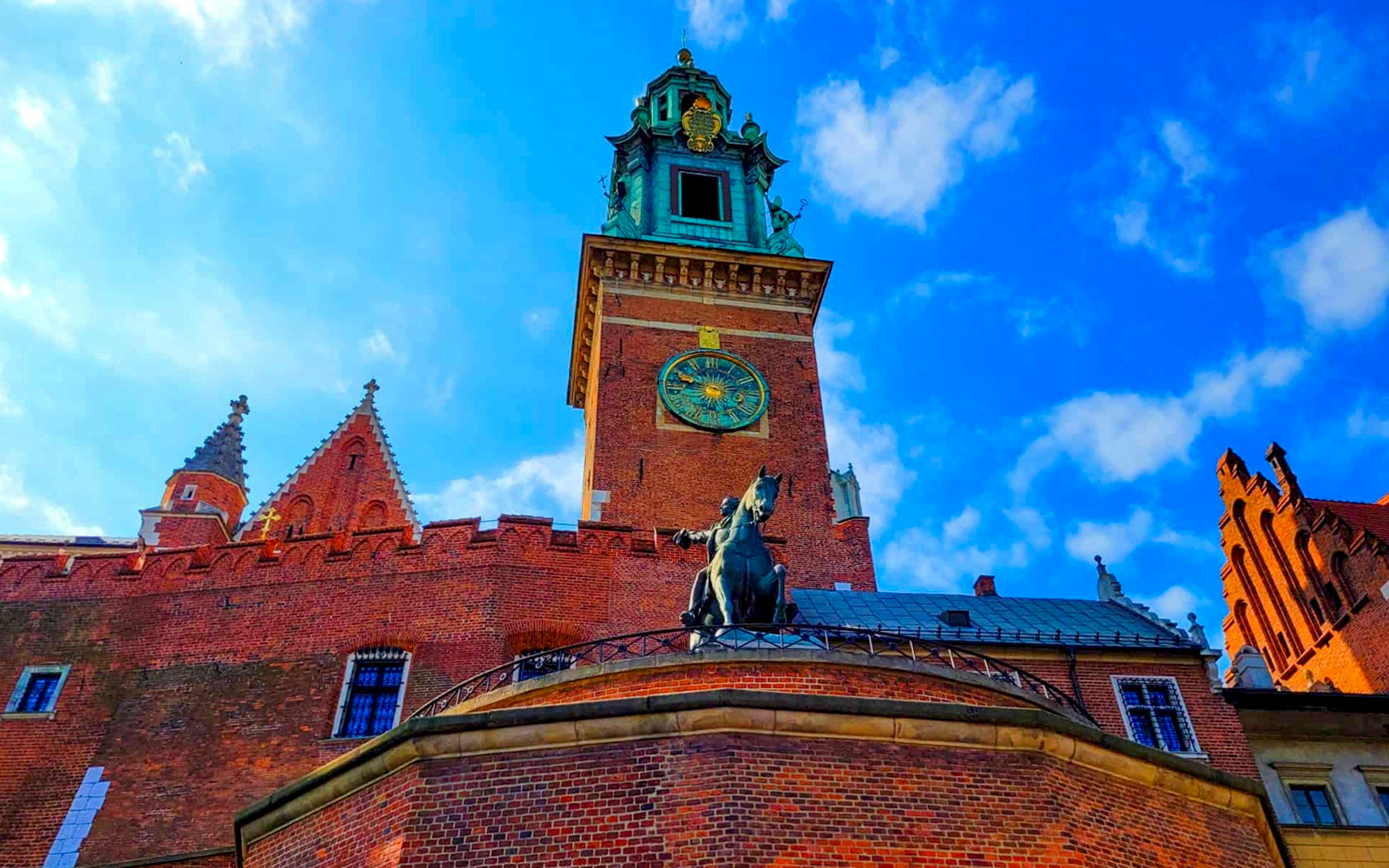 Wawel Castle tower with clock and equestrian statue in Krakow, Poland.