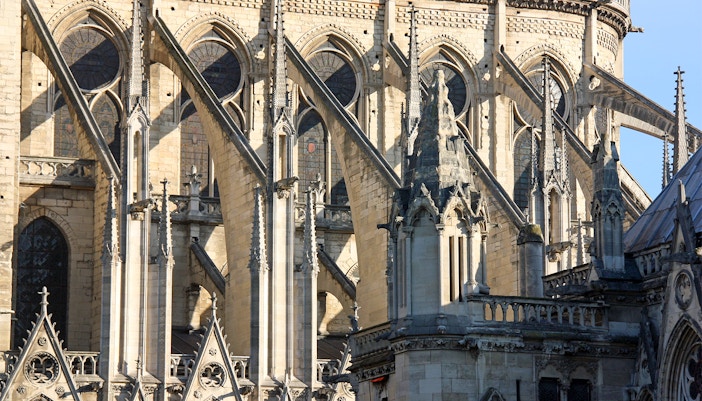 Flying buttresses of Notre Dame Cathedral in Paris, showcasing Gothic architecture.