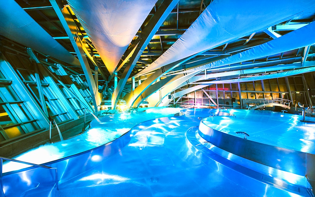 Caldea spa interior with illuminated pools and modern architecture in Andorra.