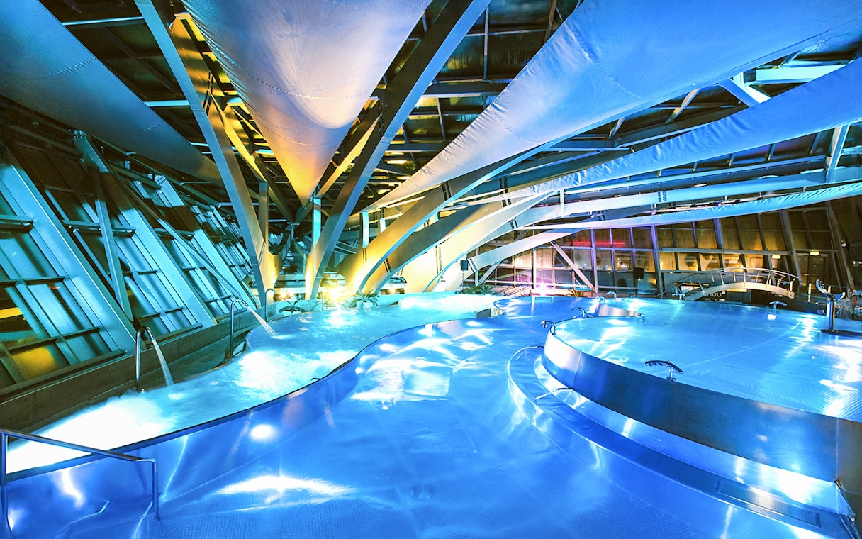 Caldea spa interior with illuminated pools and modern architecture in Andorra.