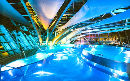 Caldea spa interior with illuminated pools and modern architecture in Andorra.