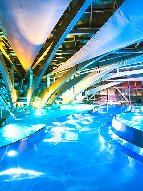 Caldea spa interior with illuminated pools and modern architecture in Andorra.