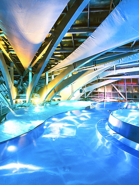 Caldea spa interior with illuminated pools and modern architecture in Andorra.