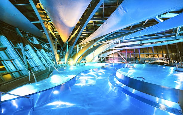 Caldea spa interior with illuminated pools and modern architecture in Andorra.