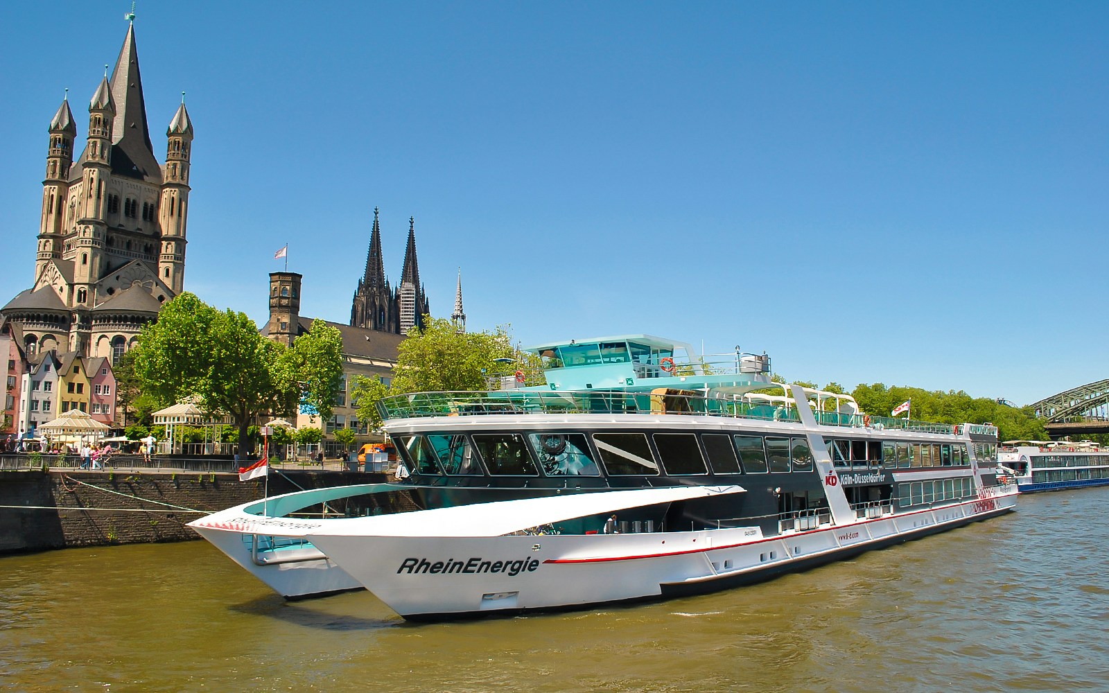 Cruise ship on the Rhine River with Cologne Cathedral in the background.