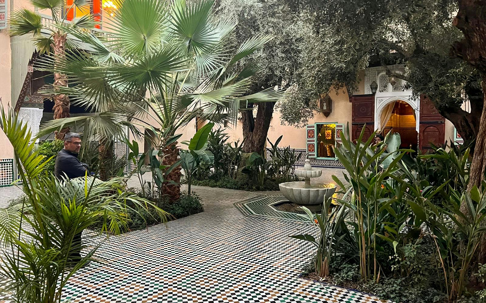 Courtyard with fountain and greenery at Moroccan Culinary Arts Museum.