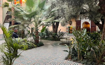 Courtyard with fountain and greenery at Moroccan Culinary Arts Museum.