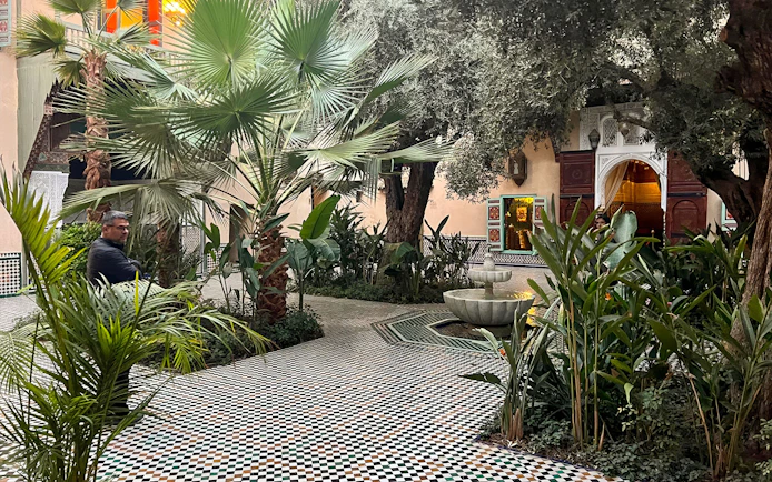 Courtyard with fountain and greenery at Moroccan Culinary Arts Museum.