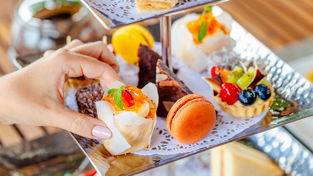 Assorted pastries on a tiered stand during high tea at Orbit revolving restaurant, Kuala Lumpur.