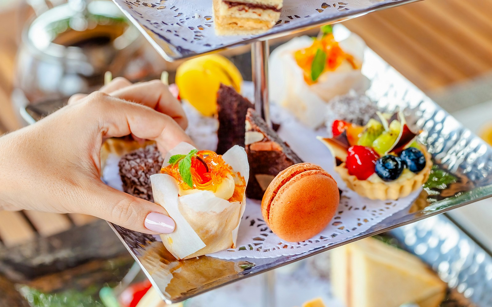 Assorted pastries on a tiered stand during high tea at Orbit revolving restaurant, Kuala Lumpur.
