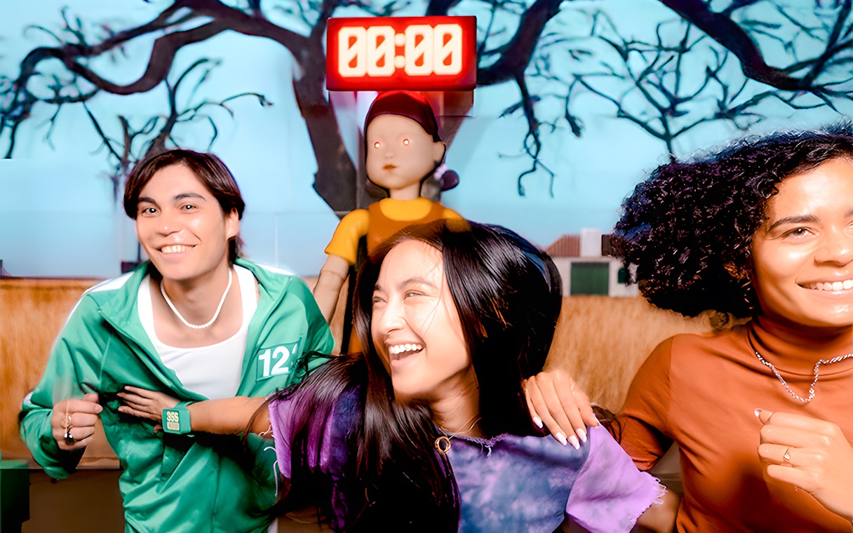 Participants enjoying Squid Games experience in London with countdown timer and game doll.