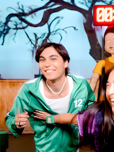 Participants enjoying Squid Games experience in London with countdown timer and game doll.