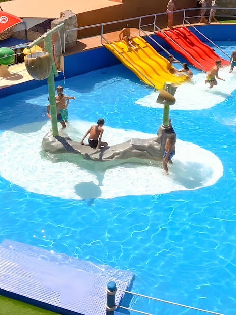 Family enjoying water slides at Marineland Mallorca pool house.