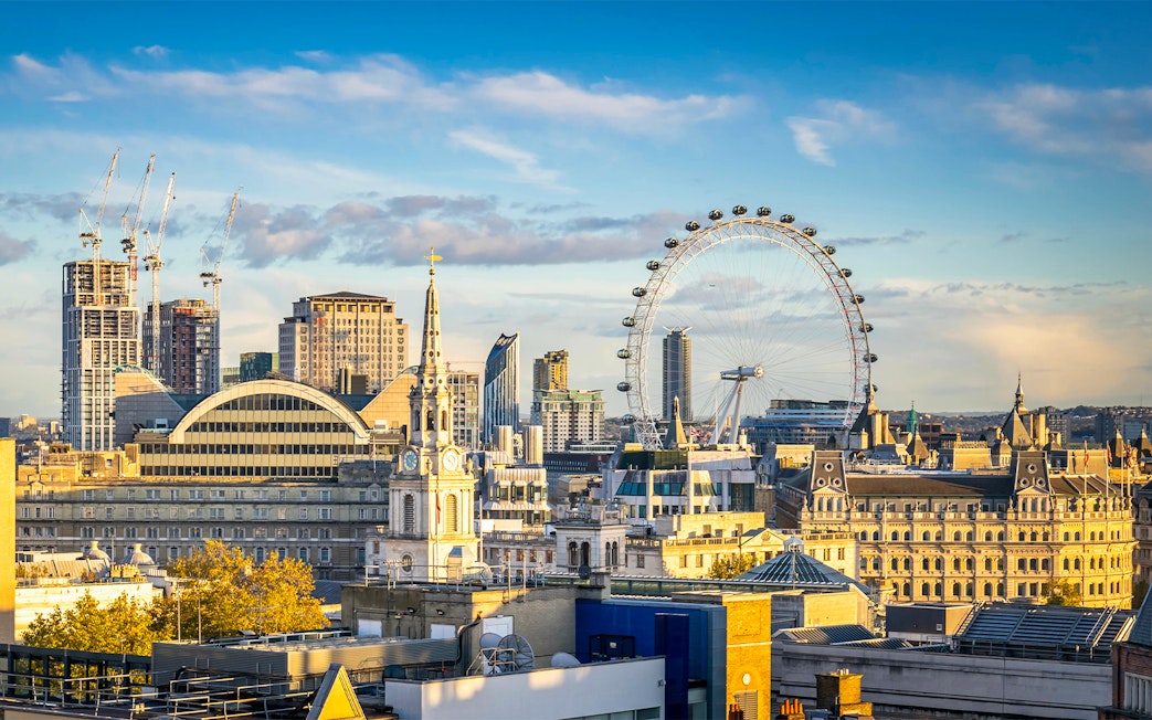 London skyline featuring the London Eye on a cloudy day.