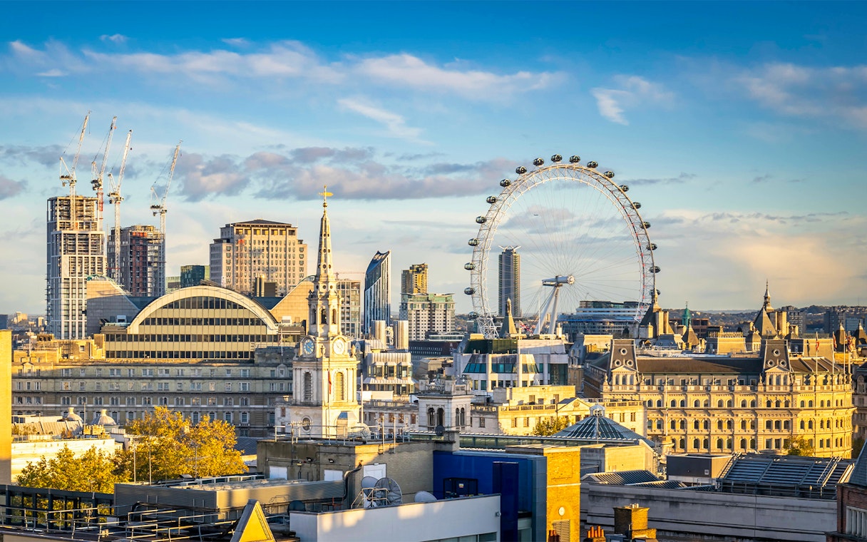 London skyline featuring the London Eye on a cloudy day.