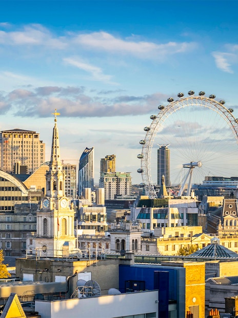 London skyline featuring the London Eye on a cloudy day.