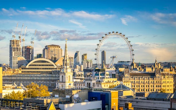 London skyline featuring the London Eye on a cloudy day.