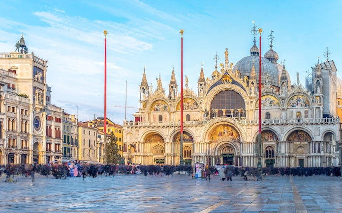 St Mark's Basilica facade with ornate arches and domes in Venice, Italy.
