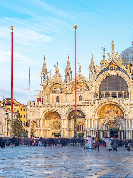 St Mark's Basilica facade with ornate arches and domes in Venice, Italy.