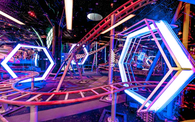 Roller coaster track with neon lights at Doha Quest Theme Park.