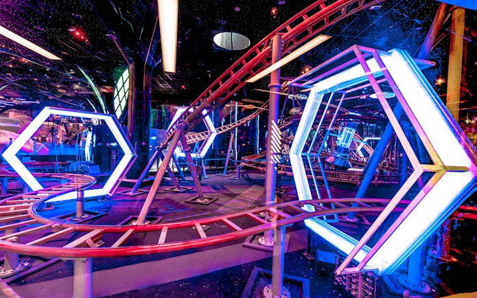 Roller coaster track with neon lights at Doha Quest Theme Park.